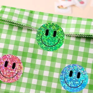 Glittery smiley face reward stickers in vibrant green, pink, and blue glitter foil.