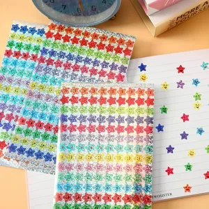 Macro detail of holographic star smiley face reward stickers applied on a lined notebook