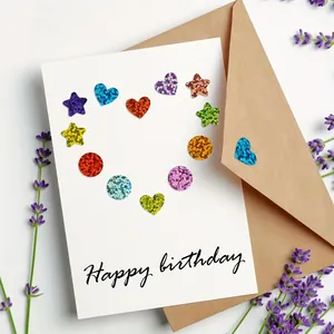 Close-up of colorful holographic star and heart stickers on a Happy Birthday card