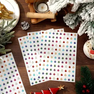 Macro detail showing multiple sheets of mini laser Christmas ball stickers for DIY crafts