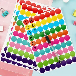 Close-up view of 19mm colorful circular dot stickers with sample handwritten markers