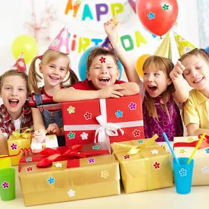 Detailed view of colorful holographic flower stickers on various party gift boxes