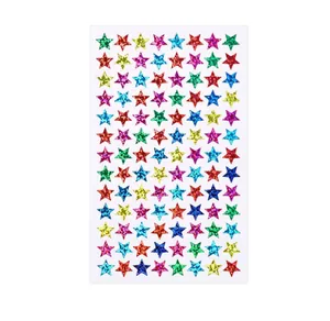 Detailed view of colorful holographic glitter star stickers on a white backing sheet