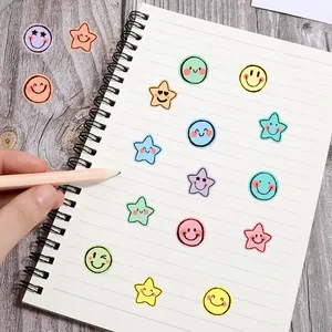 Macro detail of colorful macaron smiley and star stickers on a spiral notebook page