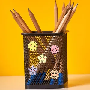 Detail view of macaron smiley face stickers on a mesh pen holder for scrapbooking