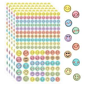 Multiple sheets of pastel macaron smiley face stickers for scrapbooking and planner decoration.