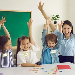 Kids wearing personalized gold foil name stickers in a classroom setting