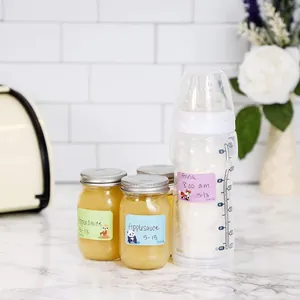 Customizable cartoon animal labels applied to baby bottles and food jars for easy organization