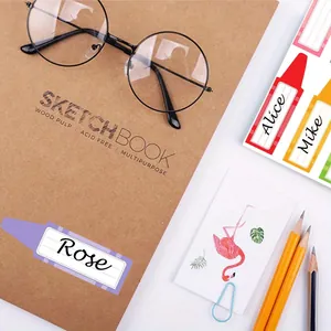 Cartoon crayon-shaped name labels on a sketchbook for school supplies