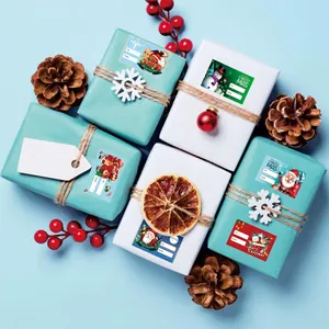 Detailed macro view of festive Christmas gift tag stickers applied to wrapped gift boxes