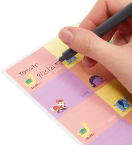 Close-up of cute cartoon animal name label stickers being written on with a grey pen.