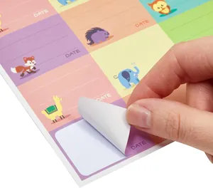 Close-up of writable cartoon animal stickers being peeled from the adhesive sheet