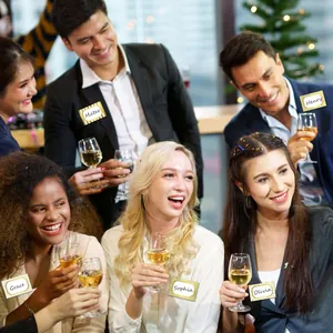 Lifestyle detail of gold border name tags applied to party clothing for social guests.