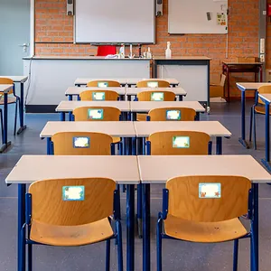 Detailed view of ocean-themed writable name stickers applied to chairs in a classroom
