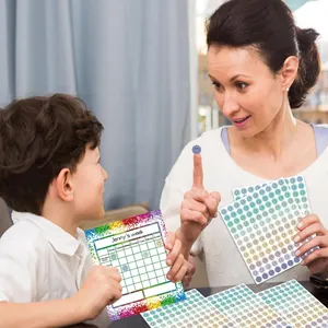 Macro detail of colorful smiley face reward stickers and chart used by mother and child
