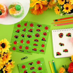 Detailed view of cute cartoon ladybug stickers applied on a spiral notebook