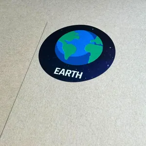 Close-up of a circular earth planet sticker with blue ocean and green land details