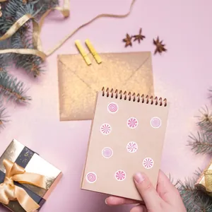 Close-up of pink swirl candy stickers applied on a kraft spiral notebook cover