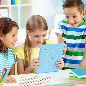 Kids decorating a blue tablet case with colorful pencil-shaped waterproof stickers.