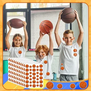 Children playing with basketball stickers applied to faces and shirts in a gym setting