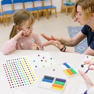 Teacher rewarding small child with colorful paw print stickers in classroom setting.