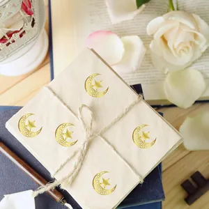 Close-up of gold foil crescent moon and star stickers for wedding invitation seals