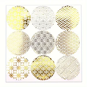 Detailed view of nine gold foiled circular stickers with intricate geometric patterns.
