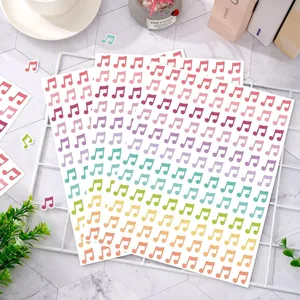 Detailed view of colorful rainbow musical note sticker sheets on a white decorative grid
