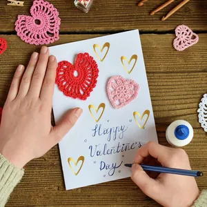 Detail view of gold foil heart stickers applied on a DIY Valentine's Day gift card
