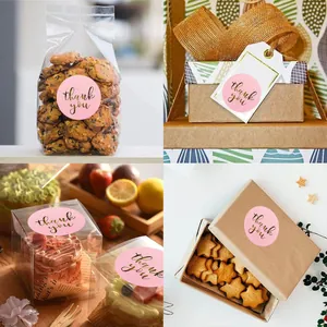 Detail view of pink 'thank you' stickers applied to various gift boxes and bags