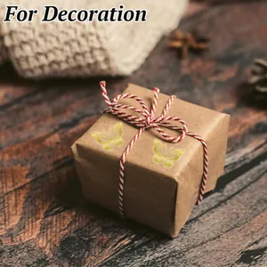 Close-up of gold foil butterfly stickers used for decorative gift box sealing