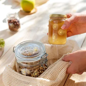 Close-up of gold foil beehive heart stickers applied to glass honey jars