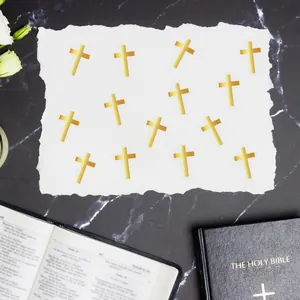 Close-up of gold foil cross stickers for wedding invitation seals and DIY crafts.