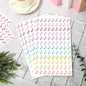 Detail shot of colorful music note stickers in a rainbow gradient for DIY journaling.