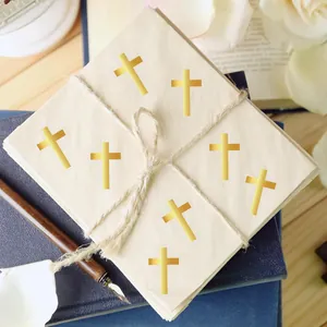 Detail of gold foil cross stickers on cream envelopes with vintage fountain pen.