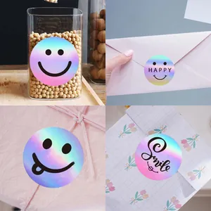 Close-up of holographic smiley face stickers used for sealing envelopes and gift wrapping.