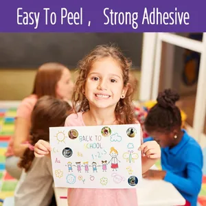 Young girl showing paper decorated with cartoon animal reward stickers in school