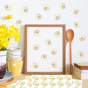 Decorative gold foil honeycomb heart stickers for wedding invitations and DIY craft projects