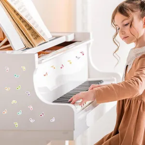 Close-up of colorful waterproof music note stickers applied to a classic white piano