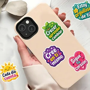 Colorful inspirational cartoon stickers with Spanish text on a beige smartphone case
