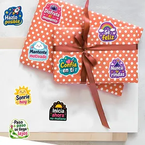 Close-up of cartoon motivational stickers in Spanish on polka dot gift wrapping paper