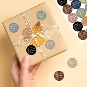 Close-up of Spanish Bible quote stickers used as gift wrap seals on a brown package.