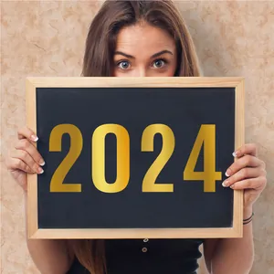 Detail view of large 2024 gold vinyl number stickers applied on a decorative chalkboard
