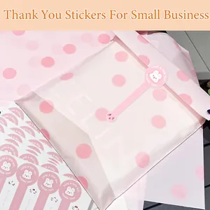 Detail view of pink rabbit thank you stickers used on a polka dot packaging bag