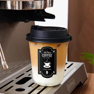 Detail of a black and white coffee sticker on a takeaway cup under a coffee machine