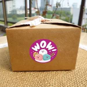 Close-up of a cute cartoon WOW! sticker used as a seal on a brown kraft gift box