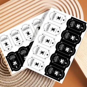 Close-up of black and white rectangular coffee themed stickers for gift box packaging labels