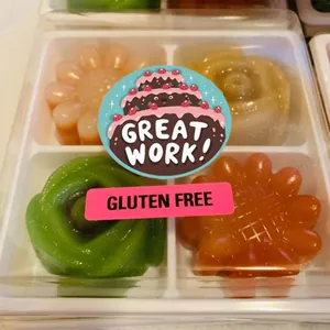 Close-up of decorative reward stickers with 'Great Work' text used for food packaging