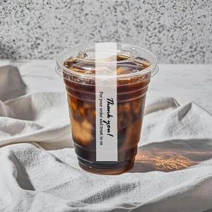 Detail view of 'Thank you' adhesive seal strip on a clear plastic iced coffee cup