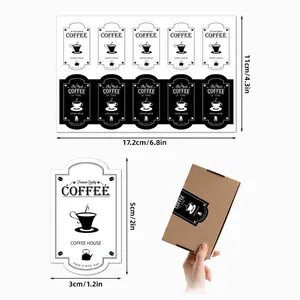 Macro detail of black and white coffee-themed decorative stickers for gift packaging.